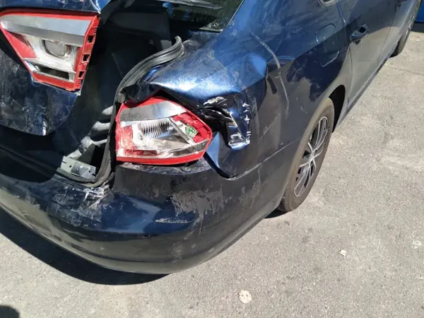 Blue sedan: rear body damage