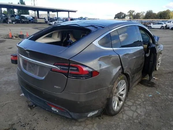 Tesla with body damage, rear view — workshop photo in Dnipro