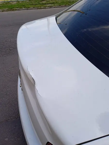 Rear body panel of a white car, detail view