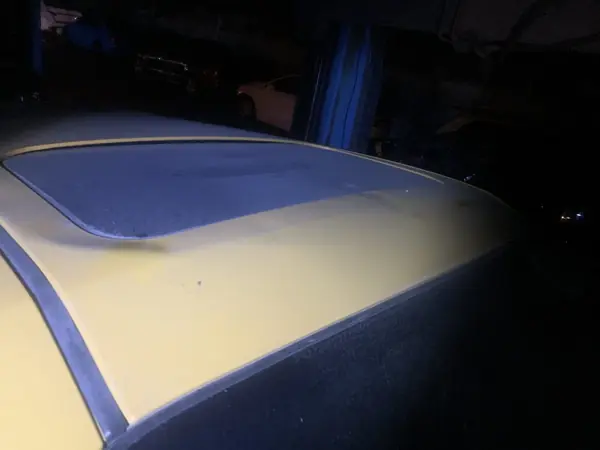 Roof panel with masking tape around the sunroof