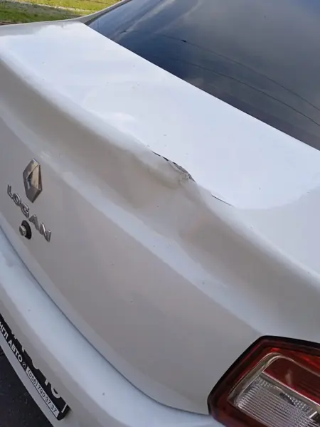 White Renault boot lid with a dent