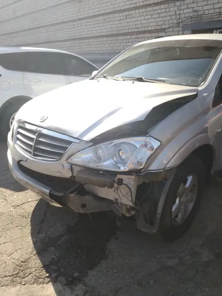 Silver sedan near the workshop