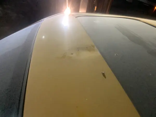 Gold-coloured roof surface under a workshop lamp