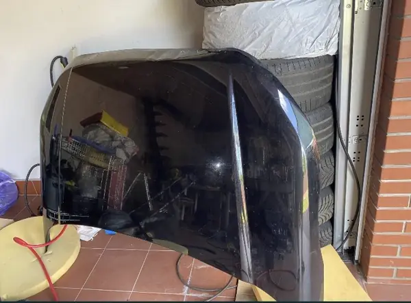 Dark body panel inside the workshop