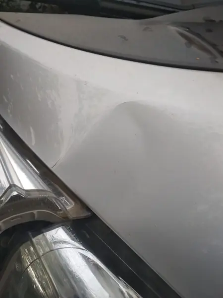 White body panel with a localised dent