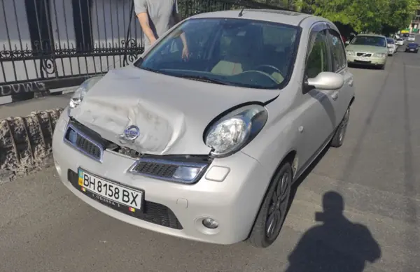 Light-coloured Nissan Micra near the workshop