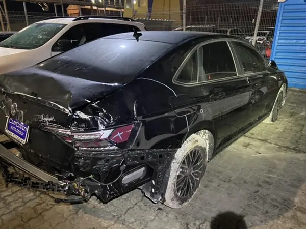 Black sedan in the workshop: rear quarter